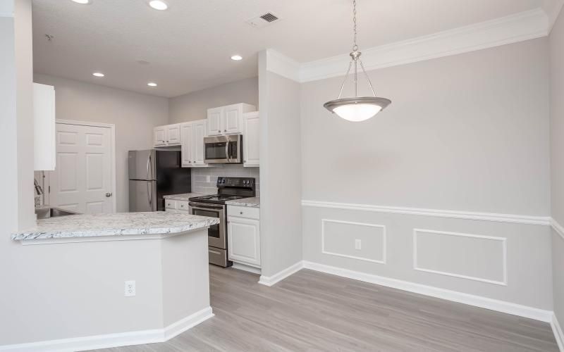 a kitchen with white cabinets